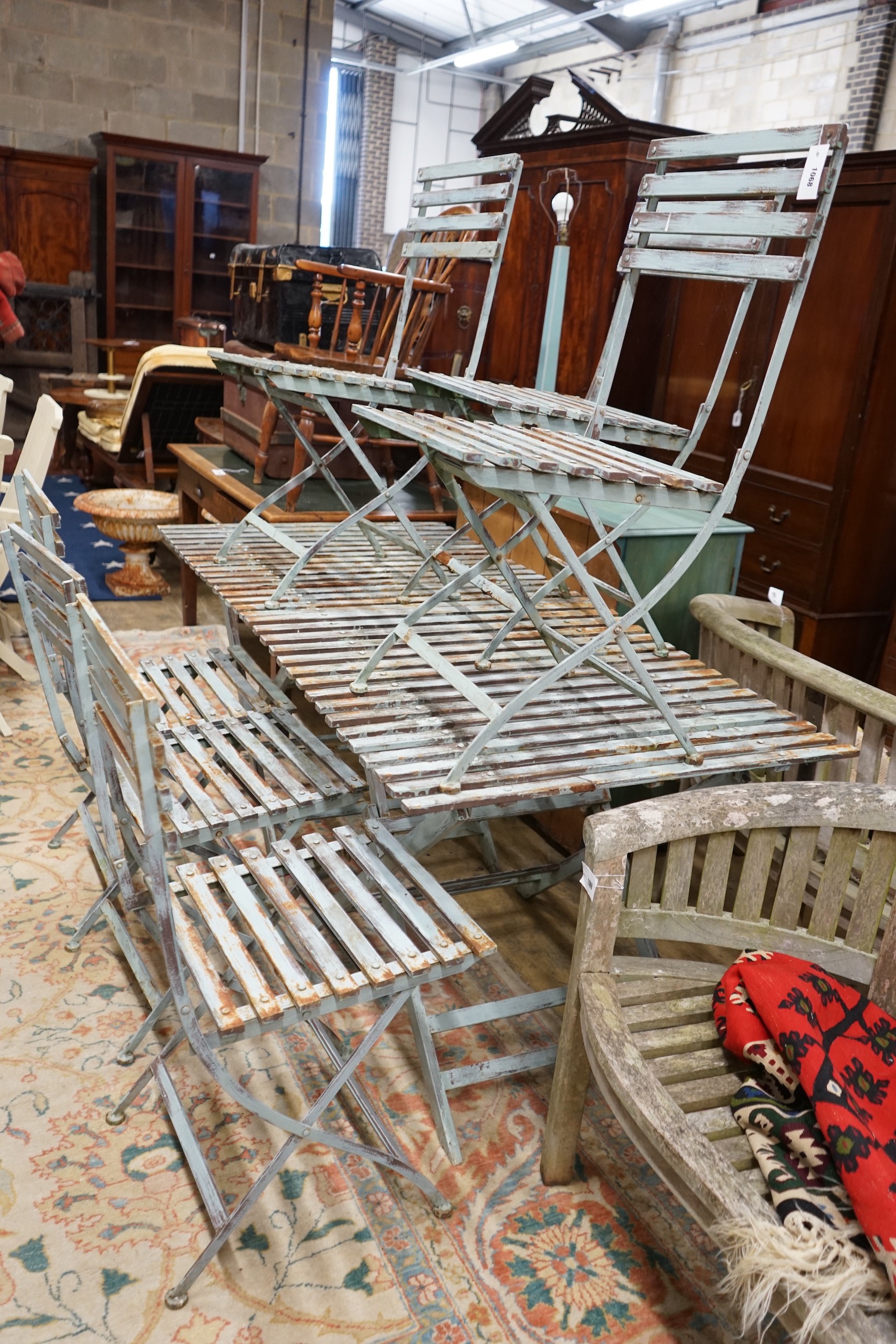 A pair of rectangular painted metal slatted garden tables, each width 86cm, depth 87cm, height 74cm and six matching folding chairs